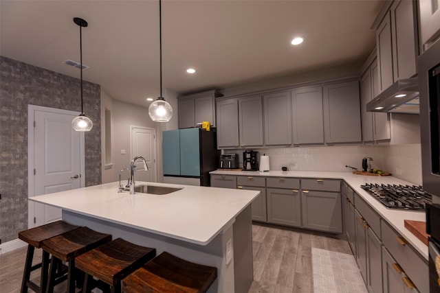 3036 Lionsgate Dr, Argyle, TX 76226 - kitchen with a sink, freestanding refrigerator, gray cabinetry, light wood-type flooring, and recessed lighting