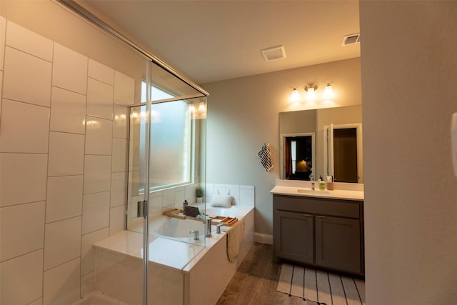 3036 Lionsgate Dr, Argyle, TX 76226 - bathroom with vanity, a bath, a stall shower, and wood finished floors