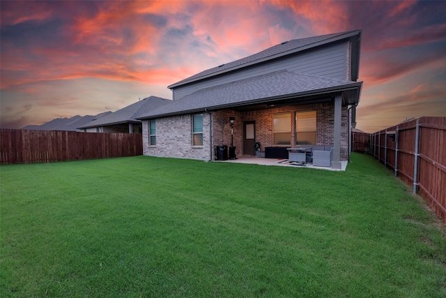 3036 Lionsgate Dr, Argyle, TX 76226 - back of house at dusk featuring a patio area, brick siding, an outdoor living space, and roof with shingles