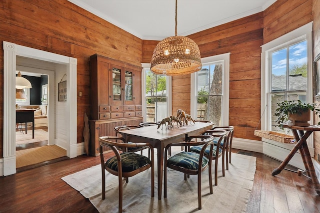 505 N College St, Mckinney, TX 75069 - dining room with plenty of natural light, wooden walls, a chandelier, hardwood / wood-style floors, and baseboards