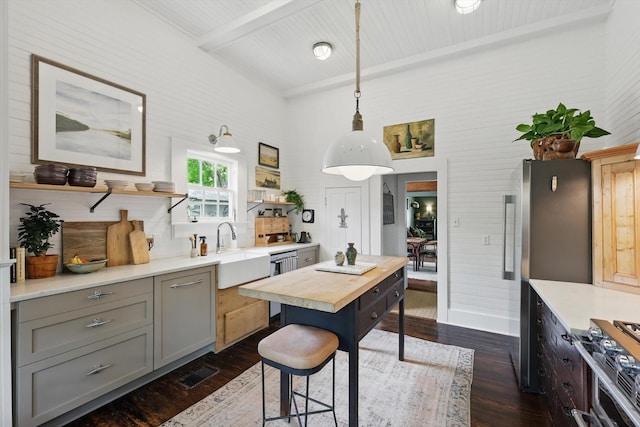 505 N College St, Mckinney, TX 75069 - kitchen with open shelves, gray cabinetry, dark wood-type flooring, appliances with stainless steel finishes, and beamed ceiling