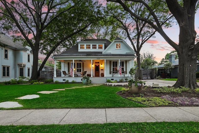 505 N College St, Mckinney, TX 75069 - view of front of house featuring covered porch, a ceiling fan, a front yard, and a shingled roof