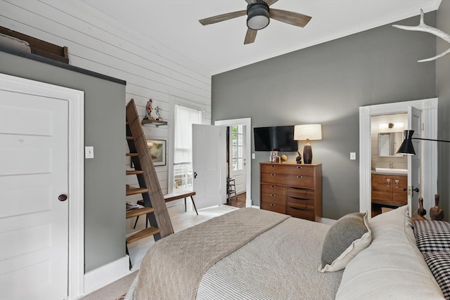 505 N College St, Mckinney, TX 75069 - bedroom featuring wooden walls, connected bathroom, a ceiling fan, and baseboards