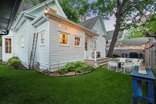 505 N College St, Mckinney, TX 75069 - back of property at dusk featuring roof with shingles