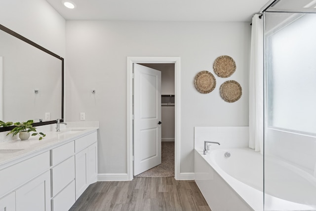 1601 Stetson St, Northlake, TX 76247 - full bathroom with double vanity, a garden tub, a spacious closet, and baseboards