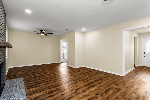 2302 Mockingbird Ln, Garland, TX 75042 - unfurnished living room with a brick fireplace, dark wood finished floors, ceiling fan, plenty of natural light, and recessed lighting