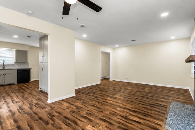 2302 Mockingbird Ln, Garland, TX 75042 - unfurnished living room with a ceiling fan, dark wood finished floors, baseboards, recessed lighting, and a sink
