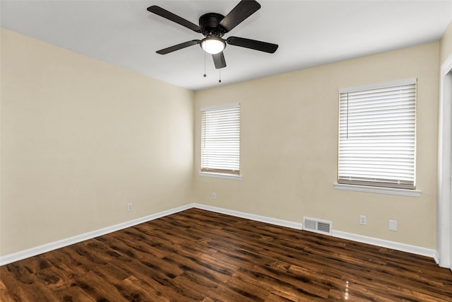 2302 Mockingbird Ln, Garland, TX 75042 - unfurnished room featuring dark wood-style flooring, baseboards, and a ceiling fan