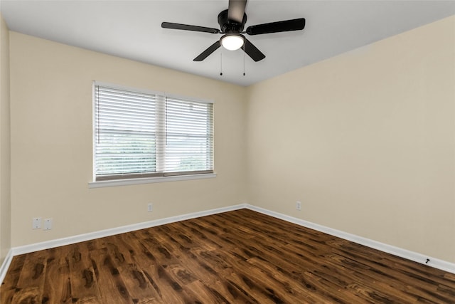 2302 Mockingbird Ln, Garland, TX 75042 - empty room featuring dark wood finished floors, baseboards, and a ceiling fan