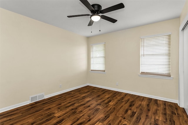 2302 Mockingbird Ln, Garland, TX 75042 - spare room with dark wood-type flooring, baseboards, and a ceiling fan