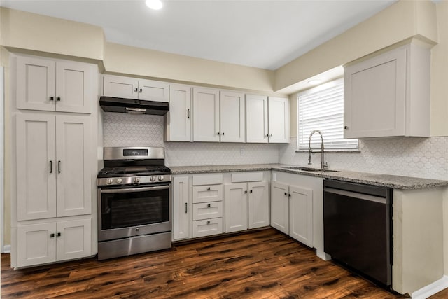 2302 Mockingbird Ln, Garland, TX 75042 - kitchen with stainless steel gas range oven, dishwashing machine, a sink, under cabinet range hood, and light stone countertops