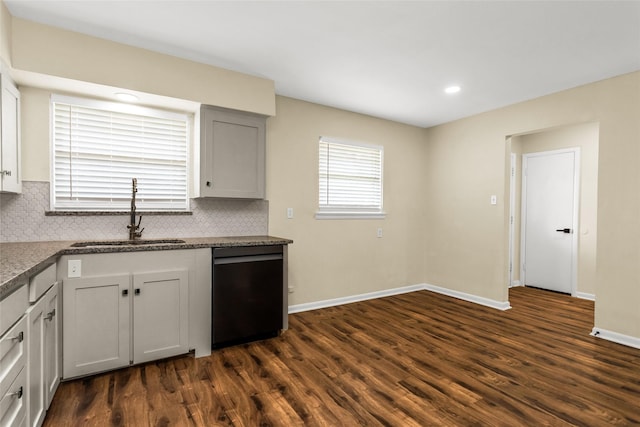 2302 Mockingbird Ln, Garland, TX 75042 - kitchen with a sink, dishwasher, dark wood finished floors, baseboards, and decorative backsplash