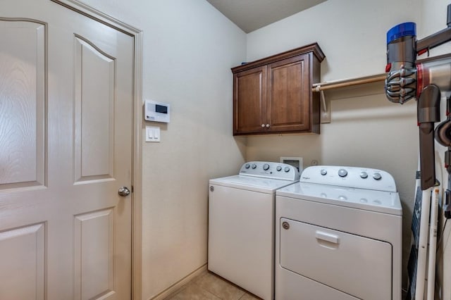 6620 Friendsway Dr, Fort Worth, TX 76137 - washroom featuring washing machine and clothes dryer, cabinet space, light tile patterned floors, and baseboards
