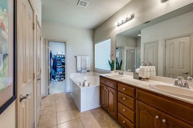 6620 Friendsway Dr, Fort Worth, TX 76137 - bathroom featuring a shower stall, double vanity, a garden tub, tile patterned floors, and a spacious closet