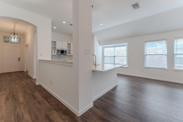 2025 Scott Creek Dr, Little Elm, TX 75068 - corridor with dark wood-style floors, baseboards, arched walkways, recessed lighting, and a chandelier