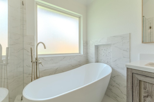 2025 Scott Creek Dr, Little Elm, TX 75068 - full bath featuring tile walls, vanity, a freestanding bath, and marble finish flooring