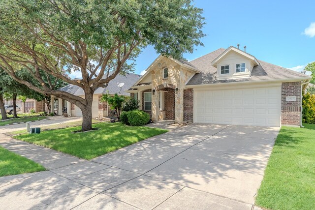 2025 Scott Creek Dr, Little Elm, TX 75068 - view of front of property featuring brick siding, driveway, a front lawn, and roof with shingles