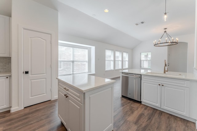 2025 Scott Creek Dr, Little Elm, TX 75068 - kitchen featuring stainless steel dishwasher, dark wood-style flooring, lofted ceiling, a sink, and white cabinets