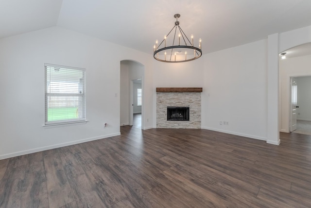 2025 Scott Creek Dr, Little Elm, TX 75068 - unfurnished living room featuring arched walkways, dark wood finished floors, a chandelier, a fireplace, and vaulted ceiling