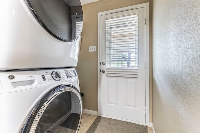 8713 Trinity Vista Trl, Fort Worth, TX 76053 - laundry room featuring stacked washer / dryer, baseboards, and light tile patterned flooring