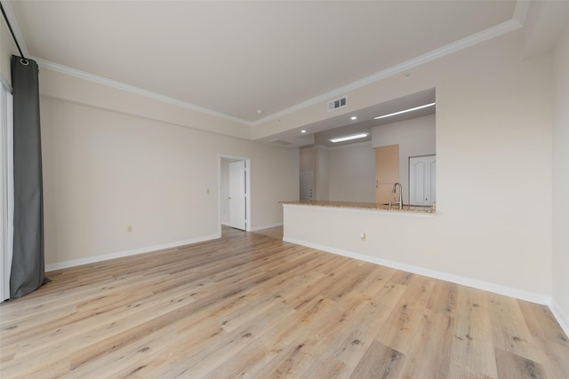3225 Turtle Creek Blvd Unit 1012, Dallas, TX 75219 - unfurnished living room with crown molding, light wood-style flooring, a sink, and baseboards