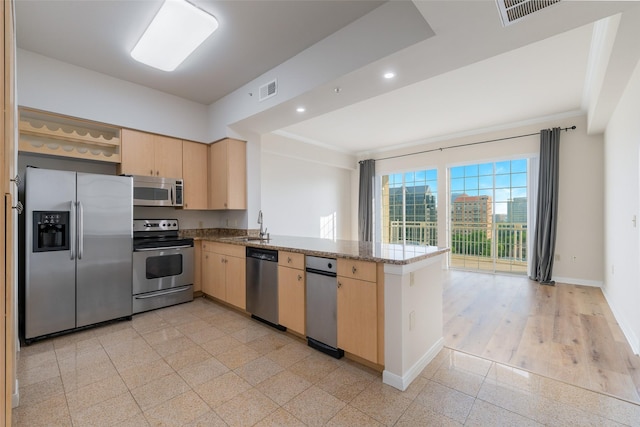 3225 Turtle Creek Blvd Unit 1012, Dallas, TX 75219 - kitchen featuring stainless steel appliances, light brown cabinetry, a peninsula, recessed lighting, and crown molding