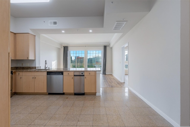 3225 Turtle Creek Blvd Unit 1012, Dallas, TX 75219 - kitchen with stainless steel dishwasher, light brown cabinets, a peninsula, baseboards, and a sink