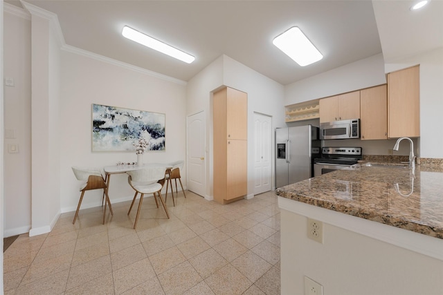 3225 Turtle Creek Blvd Unit 1012, Dallas, TX 75219 - kitchen featuring stainless steel appliances, light brown cabinetry, a sink, dark stone countertops, and baseboards