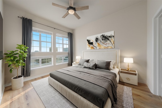 3225 Turtle Creek Blvd Unit 1012, Dallas, TX 75219 - bedroom with light wood-type flooring, baseboards, and ceiling fan