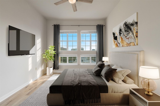 3225 Turtle Creek Blvd Unit 1012, Dallas, TX 75219 - bedroom with wood finished floors, baseboards, and a ceiling fan