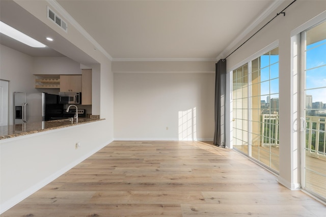 3225 Turtle Creek Blvd Unit 1012, Dallas, TX 75219 - unfurnished living room with light wood-style floors, ornamental molding, baseboards, and a sink