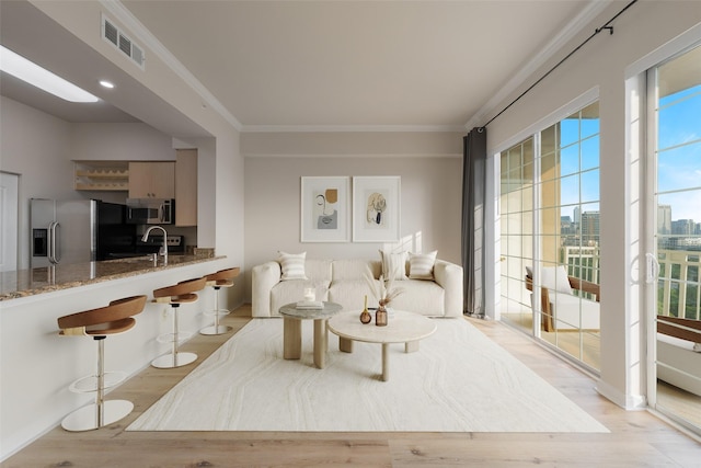 3225 Turtle Creek Blvd Unit 1012, Dallas, TX 75219 - living area featuring light wood-type flooring, crown molding, and a view of city