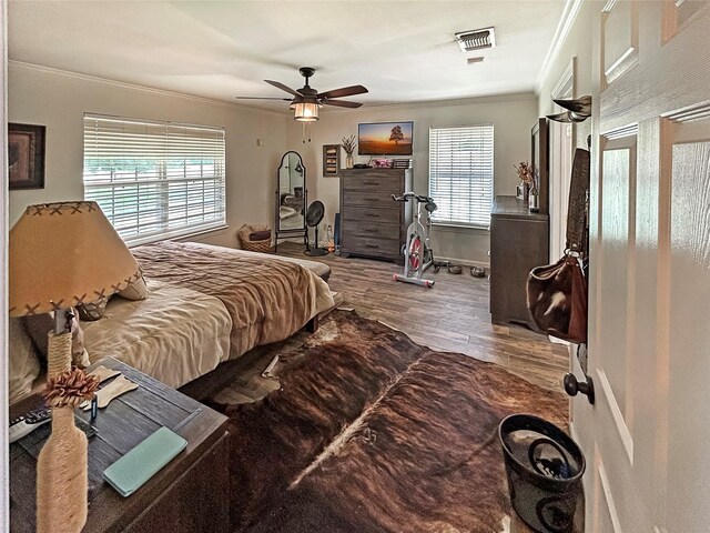 434 Thornton Ln, Palo Pinto, TX 76484 - bedroom featuring crown molding, multiple windows, wood finished floors, baseboards, and ceiling fan