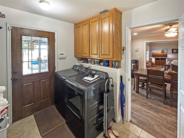 434 Thornton Ln, Palo Pinto, TX 76484 - laundry room featuring separate washer and dryer, cabinet space, a ceiling fan, and light tile patterned flooring