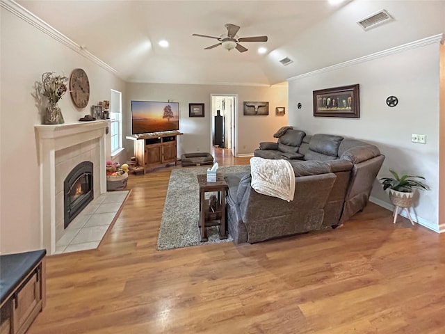434 Thornton Ln, Palo Pinto, TX 76484 - living area with a ceiling fan, crown molding, vaulted ceiling, light wood-style flooring, and a tile fireplace