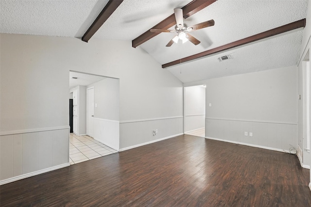 815 Quail Ter, Mansfield, TX 76063 - empty room featuring a textured ceiling, wood finished floors, ceiling fan, and wainscoting