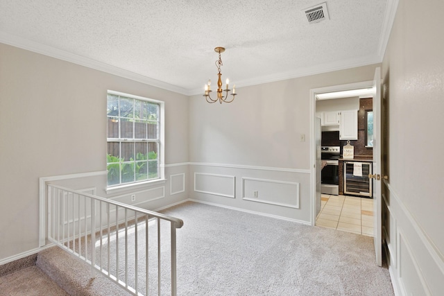 1019 W Lovers Ln W, Arlington, TX 76013 - empty room featuring wine cooler, a chandelier, light colored carpet, ornamental molding, and a wainscoted wall