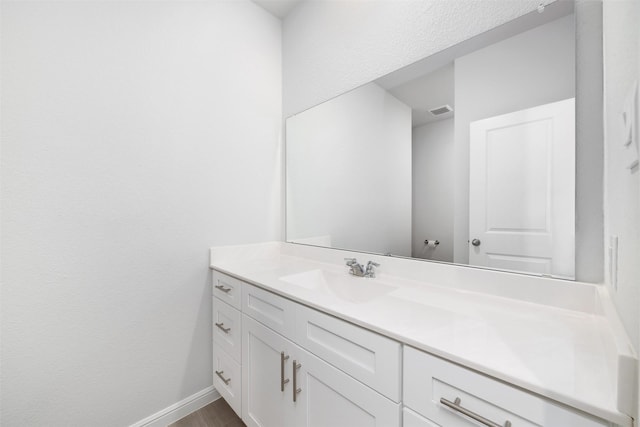 9653 Alderleaf Trl, Fort Worth, TX 76036 - bathroom featuring vanity, baseboards, and wood finished floors