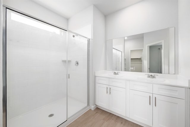 9653 Alderleaf Trl, Fort Worth, TX 76036 - full bathroom with a stall shower, wood finished floors, and double vanity
