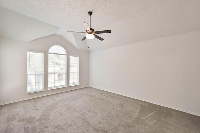 7405 Mesa Verde Trl, Fort Worth, TX 76137 - empty room with carpet, ceiling fan, vaulted ceiling, baseboards, and a textured ceiling
