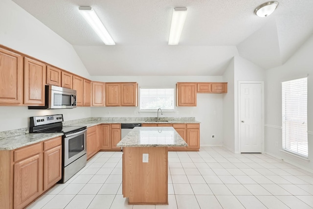 7405 Mesa Verde Trl, Fort Worth, TX 76137 - kitchen featuring stainless steel appliances, lofted ceiling, a kitchen island, a sink, and light stone countertops