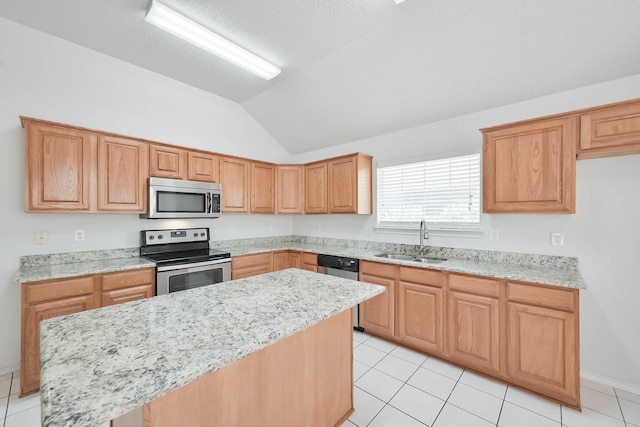 7405 Mesa Verde Trl, Fort Worth, TX 76137 - kitchen featuring appliances with stainless steel finishes, a sink, light tile patterned flooring, and vaulted ceiling
