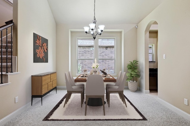 205 Hogue Ln, Wylie, TX 75098 - dining room featuring a chandelier, arched walkways, light colored carpet, and baseboards