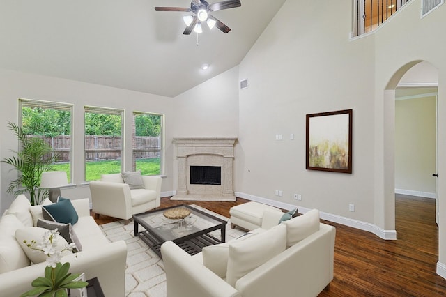 205 Hogue Ln, Wylie, TX 75098 - living room featuring arched walkways, high vaulted ceiling, baseboards, a ceiling fan, and wood finished floors