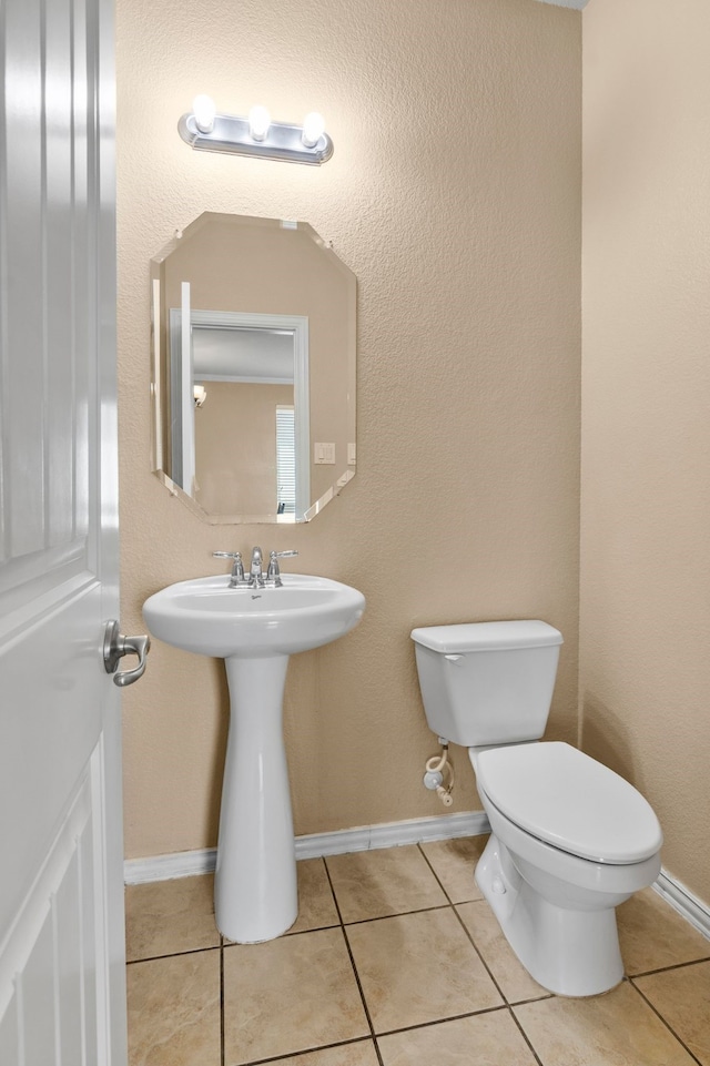 12001 Walden Wood Dr, Fort Worth, TX 76244 - bathroom with toilet, tile patterned floors, baseboards, and a sink