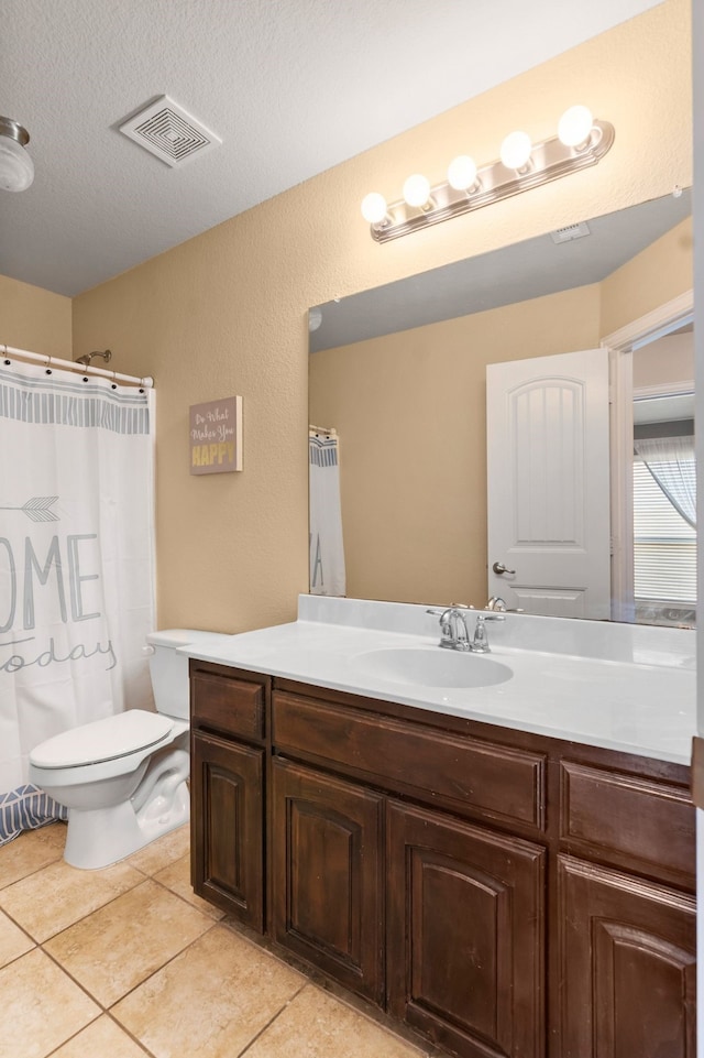 12001 Walden Wood Dr, Fort Worth, TX 76244 - bathroom with vanity, toilet, tile patterned floors, a textured ceiling, and a textured wall