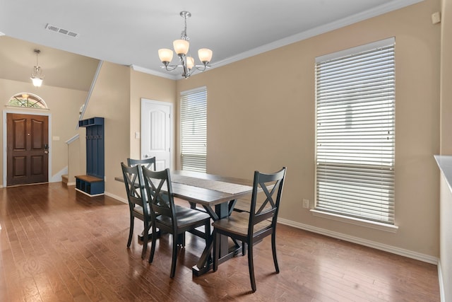 12001 Walden Wood Dr, Fort Worth, TX 76244 - dining room with a chandelier, baseboards, hardwood / wood-style floors, plenty of natural light, and crown molding