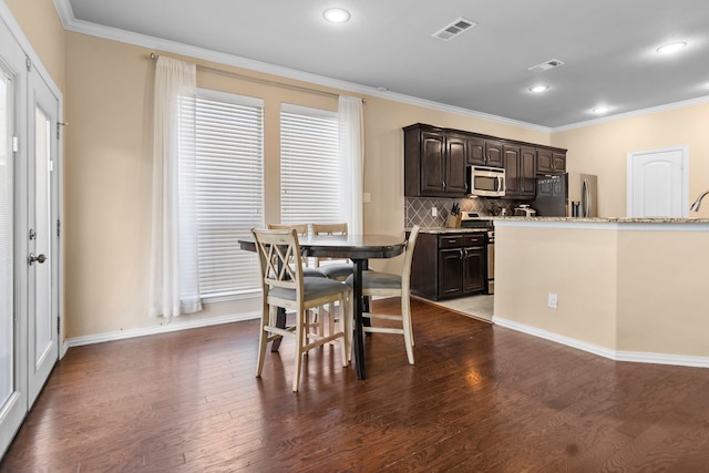 12001 Walden Wood Dr, Fort Worth, TX 76244 - dining room with dark wood finished floors, ornamental molding, baseboards, and recessed lighting