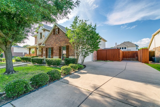 3801 Emerald Park Dr, Corinth, TX 76208 - view of front facade featuring brick siding, a gate, central air condition unit, concrete driveway, and an attached garage