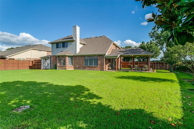 3801 Emerald Park Dr, Corinth, TX 76208 - back of property with a chimney, brick siding, and a shingled roof
